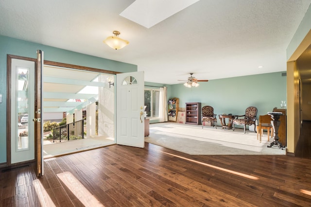 4706 Glenwood Hills Dr NE, Albuquerque, NM 87111 - foyer entrance featuring wood finished floors, ceiling fan, and a skylight