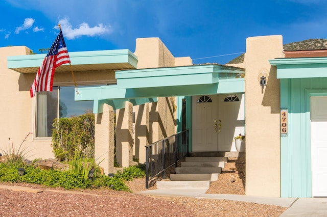 4706 Glenwood Hills Dr NE, Albuquerque, NM 87111 - doorway to property with stucco siding and board and batten siding