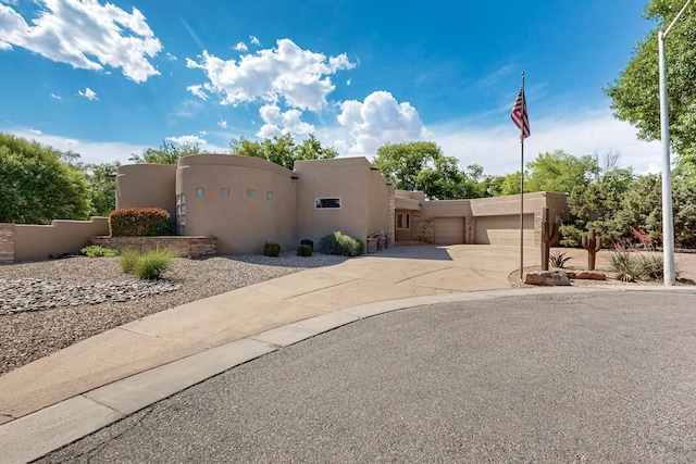 2600 Griegos Pl NW, Albuquerque, NM 87107 - southwest-style home featuring stucco siding, concrete driveway, and an attached garage