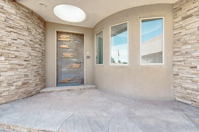 2600 Griegos Pl NW, Albuquerque, NM 87107 - view of exterior entry featuring stone siding and stucco siding