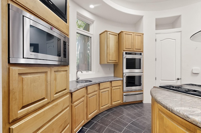 2600 Griegos Pl NW, Albuquerque, NM 87107 - kitchen featuring appliances with stainless steel finishes, a warming drawer, a sink, light brown cabinets, and light countertops