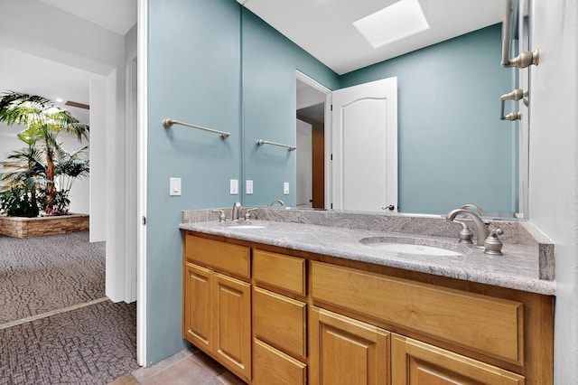 2600 Griegos Pl NW, Albuquerque, NM 87107 - bathroom with a skylight, double vanity, and tile patterned flooring