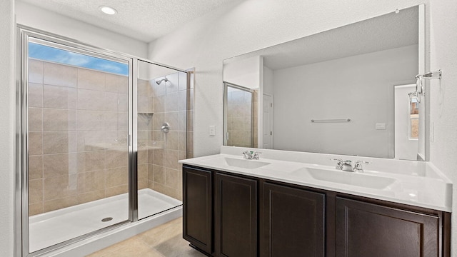 1660 Maggie Dr, Rio Rancho, NM 87144 - full bathroom with a stall shower, double vanity, a textured ceiling, and tile patterned flooring