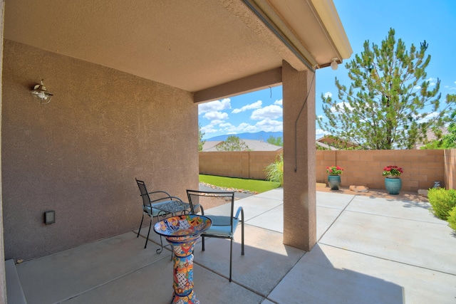7217 Skagway Dr NE, Rio Rancho, NM 87144 - fenced backyard featuring a patio area and a mountain view