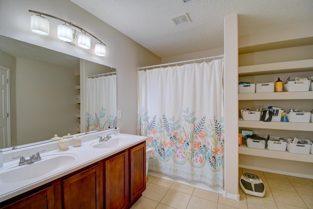 7217 Skagway Dr NE, Rio Rancho, NM 87144 - bathroom featuring a textured ceiling, double vanity, tile patterned flooring, and a shower with shower curtain