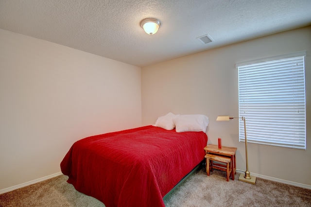 7217 Skagway Dr NE, Rio Rancho, NM 87144 - bedroom featuring carpet flooring, baseboards, and a textured ceiling
