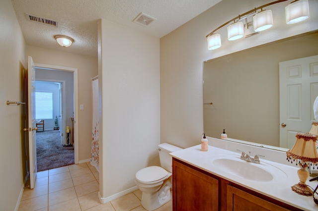 7217 Skagway Dr NE, Rio Rancho, NM 87144 - bathroom with vanity, a textured ceiling, toilet, tile patterned floors, and a shower with shower curtain