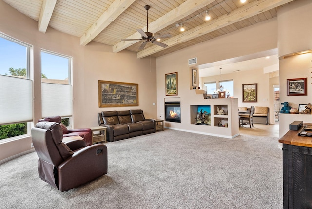 3424 Calle Suenos SE, Rio Rancho, NM 87124 - carpeted living room featuring a wooden ceiling with exposed beams, a ceiling fan, and a chandelier