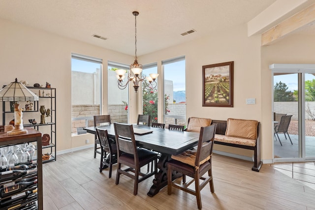 3424 Calle Suenos SE, Rio Rancho, NM 87124 - dining area with a chandelier and light wood-style floors