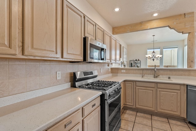 3424 Calle Suenos SE, Rio Rancho, NM 87124 - kitchen featuring appliances with stainless steel finishes, light brown cabinets, backsplash, recessed lighting, and beam ceiling