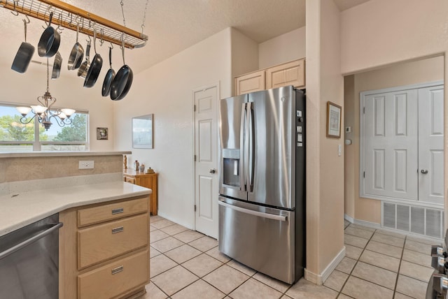 3424 Calle Suenos SE, Rio Rancho, NM 87124 - kitchen featuring stainless steel appliances, light brown cabinets, light tile patterned floors, light countertops, and a chandelier