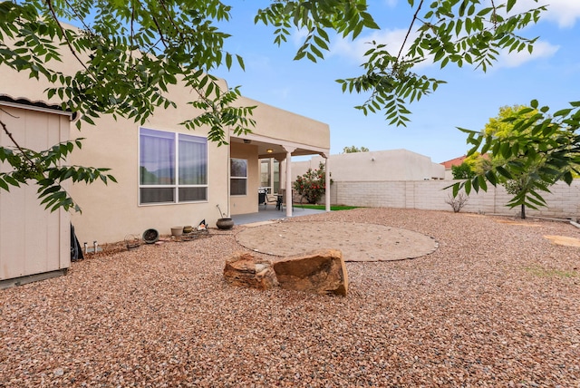 3424 Calle Suenos SE, Rio Rancho, NM 87124 - rear view of house with a fenced backyard, stucco siding, and a patio area