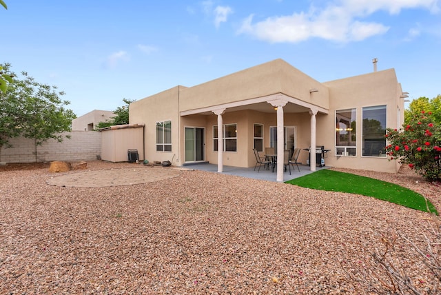 3424 Calle Suenos SE, Rio Rancho, NM 87124 - back of house with stucco siding and a patio area