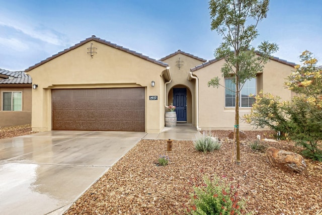 2927 Kings Canyon Loop NE, Rio Rancho, NM 87144 - mediterranean / spanish home featuring driveway, a garage, stucco siding, and a tiled roof
