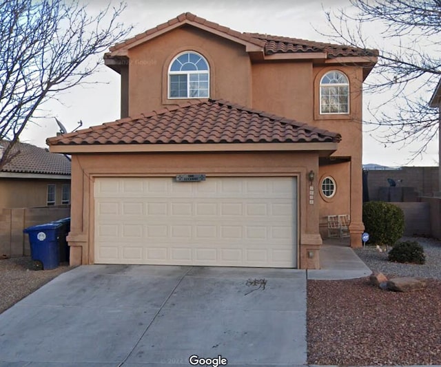 4608 Stafford Pl NW, Albuquerque, NM 87120 - mediterranean / spanish house featuring driveway, a tiled roof, and stucco siding