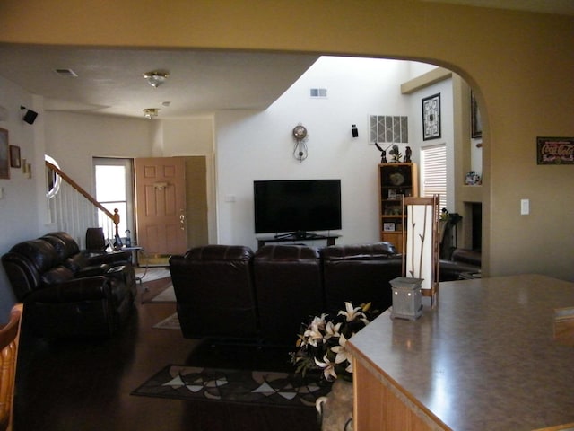 4608 Stafford Pl NW, Albuquerque, NM 87120 - living room with arched walkways, a fireplace, and stairway