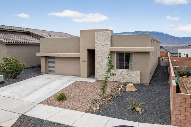 6854 Cleary Loop NE, Rio Rancho, NM 87144 - adobe home with concrete driveway, a mountain view, a garage, and stucco siding