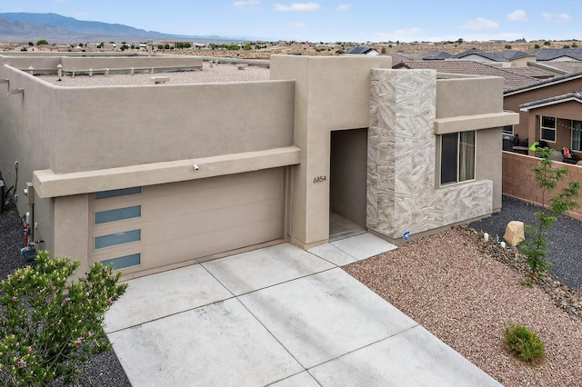 6854 Cleary Loop NE, Rio Rancho, NM 87144 - southwest-style home with stucco siding, concrete driveway, a mountain view, and a garage