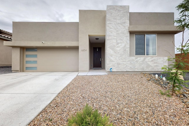 6854 Cleary Loop NE, Rio Rancho, NM 87144 - view of front of property featuring driveway, stucco siding, and a garage
