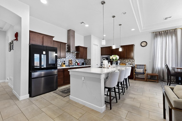 6854 Cleary Loop NE, Rio Rancho, NM 87144 - kitchen with smart refrigerator, wall chimney range hood, light countertops, tasteful backsplash, and stainless steel gas stovetop