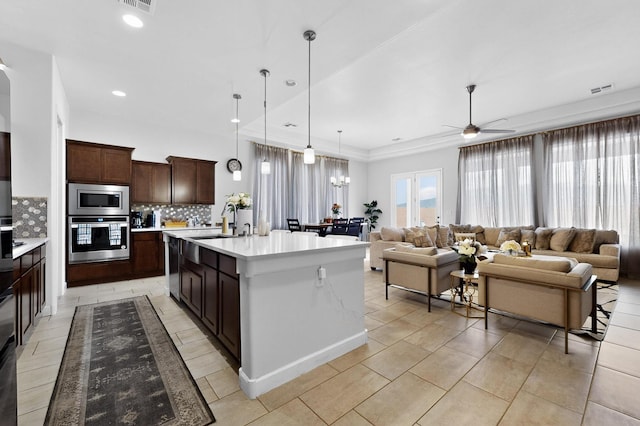 6854 Cleary Loop NE, Rio Rancho, NM 87144 - kitchen with appliances with stainless steel finishes, open floor plan, tasteful backsplash, a ceiling fan, and light countertops