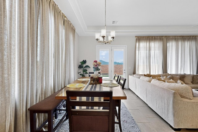 6854 Cleary Loop NE, Rio Rancho, NM 87144 - dining space featuring a chandelier and a tray ceiling