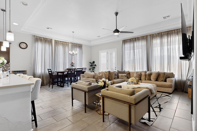 6854 Cleary Loop NE, Rio Rancho, NM 87144 - living area featuring healthy amount of natural light, a tray ceiling, ceiling fan, a chandelier, and recessed lighting