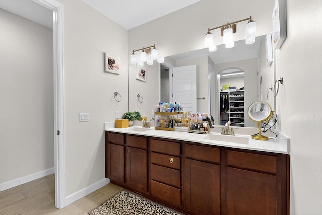 6854 Cleary Loop NE, Rio Rancho, NM 87144 - full bathroom featuring double vanity, a spacious closet, and wood finished floors