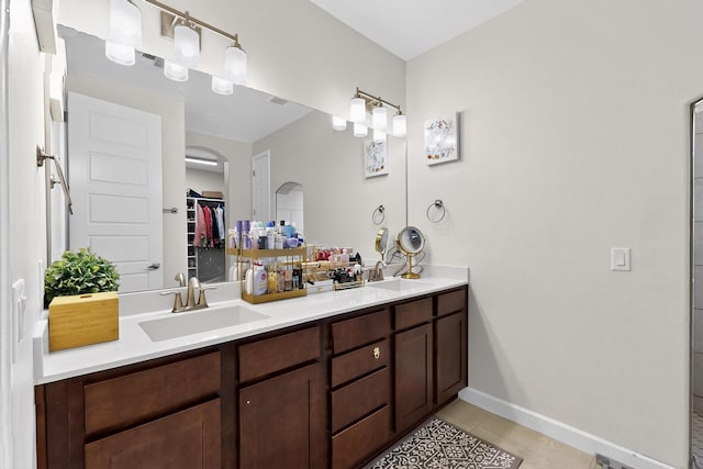 6854 Cleary Loop NE, Rio Rancho, NM 87144 - bathroom featuring double vanity, tile patterned flooring, and a spacious closet