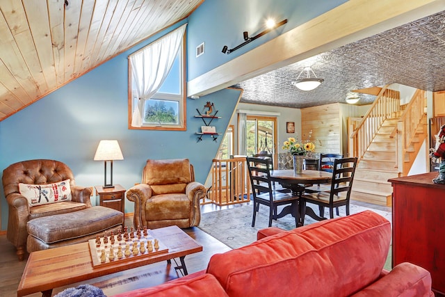 280 Ponderosa Way, Jemez Springs, NM 87025 - living area featuring stairs, wood finished floors, wooden walls, wood ceiling, and vaulted ceiling