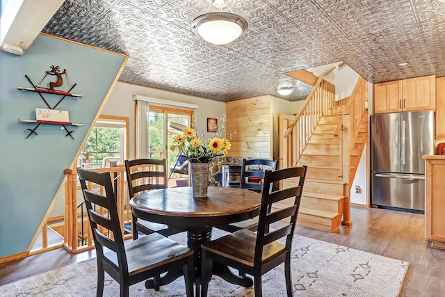 280 Ponderosa Way, Jemez Springs, NM 87025 - dining area with an ornate ceiling, stairway, wood walls, light wood finished floors, and baseboards