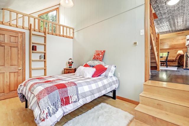 280 Ponderosa Way, Jemez Springs, NM 87025 - bedroom with wood walls, wood finished floors, and baseboards