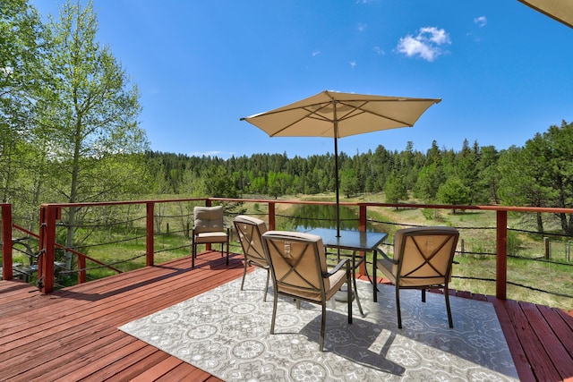 280 Ponderosa Way, Jemez Springs, NM 87025 - wooden deck featuring a wooded view and outdoor dining space
