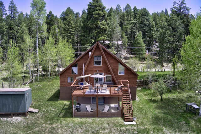280 Ponderosa Way, Jemez Springs, NM 87025 - rear view of house with stairs, a wooden deck, a lawn, and a forest view