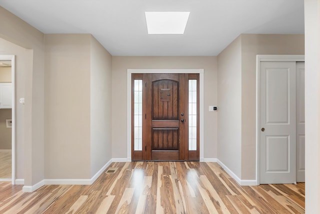 8320 Cherry Hills Dr NE, Albuquerque, NM 87111 - foyer entrance featuring light wood-type flooring, baseboards, and a skylight