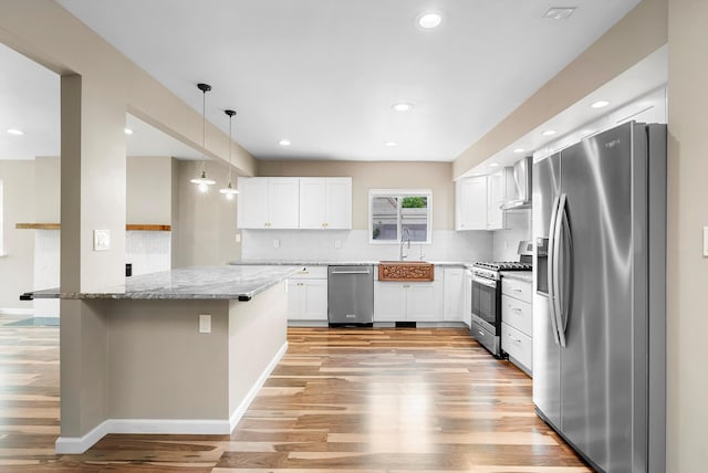 8320 Cherry Hills Dr NE, Albuquerque, NM 87111 - kitchen featuring appliances with stainless steel finishes, a sink, light wood-type flooring, light stone countertops, and white cabinets