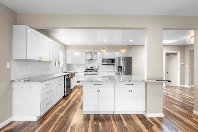 8320 Cherry Hills Dr NE, Albuquerque, NM 87111 - kitchen featuring appliances with stainless steel finishes, dark wood-style flooring, wall chimney range hood, white cabinets, and tasteful backsplash