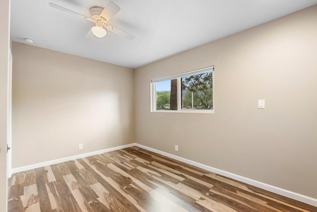 8320 Cherry Hills Dr NE, Albuquerque, NM 87111 - spare room featuring wood finished floors, baseboards, a ceiling fan, and a smoke detector