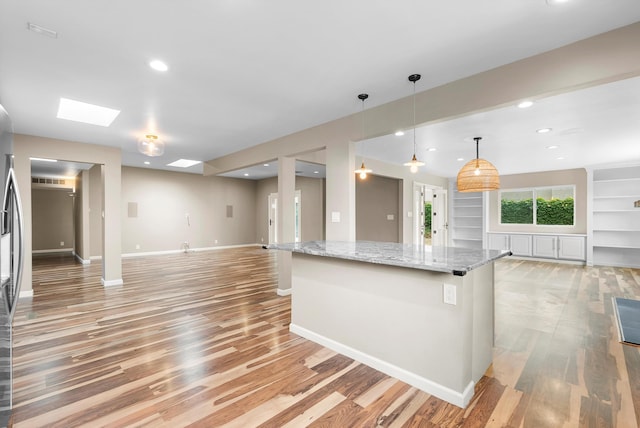 8320 Cherry Hills Dr NE, Albuquerque, NM 87111 - kitchen featuring open floor plan, light wood-style floors, light stone counters, baseboards, and recessed lighting