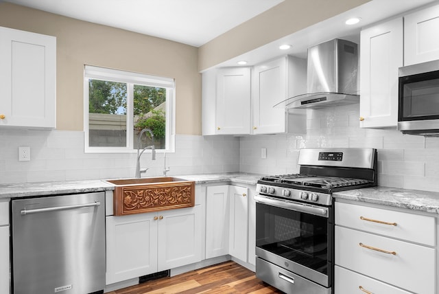 8320 Cherry Hills Dr NE, Albuquerque, NM 87111 - kitchen with stainless steel appliances, wall chimney range hood, white cabinets, a sink, and light stone counters