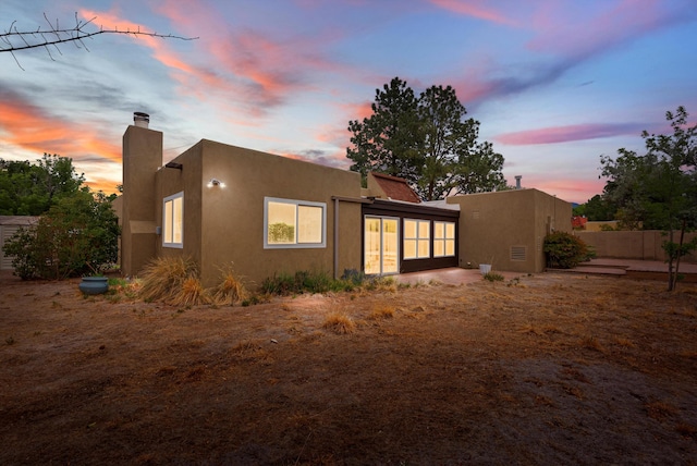 8320 Cherry Hills Dr NE, Albuquerque, NM 87111 - rear view of house with stucco siding and a chimney