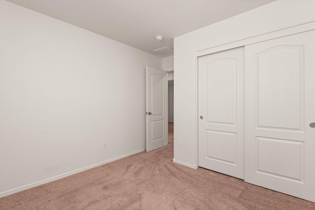 2425 Desi Loop, Belen, NM 87002 - unfurnished bedroom featuring light colored carpet, a closet, and baseboards