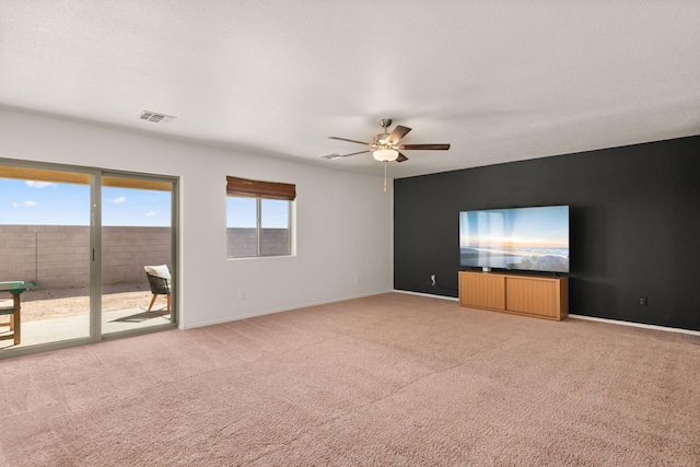 2425 Desi Loop, Belen, NM 87002 - spare room with light carpet, ceiling fan, and baseboards