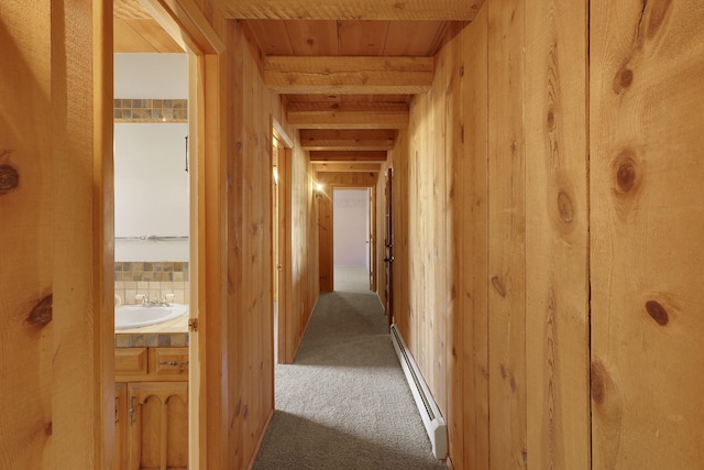 9705 Rio Grande Blvd NW, Albuquerque, NM 87114 - hallway with a baseboard radiator, carpet flooring, a sink, wooden ceiling, and wooden walls
