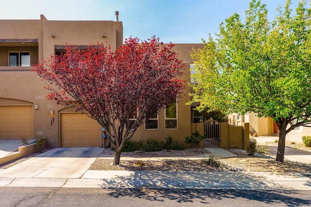 8736 Desert Fox Way NE, Albuquerque, NM 87122 - southwest-style home with driveway, stucco siding, and a gate