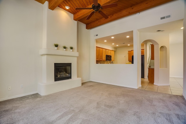 8736 Desert Fox Way NE, Albuquerque, NM 87122 - unfurnished living room featuring a wood ceiling with exposed beams, ceiling fan, light colored carpet, a fireplace, and recessed lighting