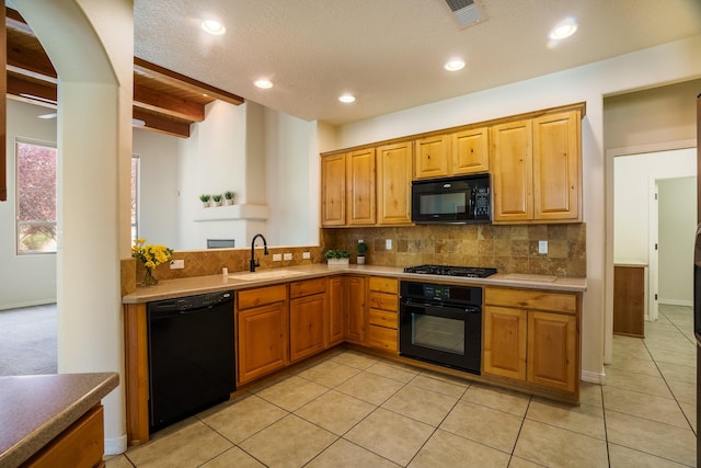 8736 Desert Fox Way NE, Albuquerque, NM 87122 - kitchen featuring black appliances, light tile patterned flooring, tasteful backsplash, beamed ceiling, and recessed lighting