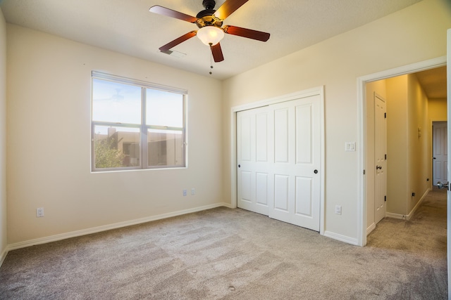 8736 Desert Fox Way NE, Albuquerque, NM 87122 - unfurnished bedroom featuring carpet floors, a closet, and a ceiling fan