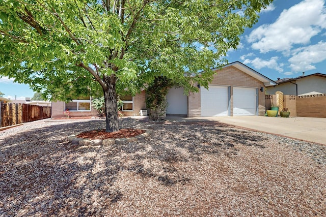 7313 Valley Forge Rd NE, Albuquerque, NM 87109 - view of front of home featuring brick siding, driveway, and an attached garage