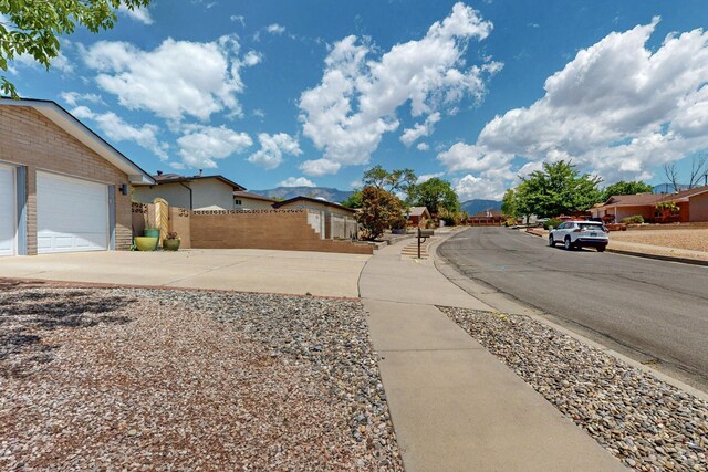 7313 Valley Forge Rd NE, Albuquerque, NM 87109 - view of asphalt street featuring sidewalks, curbs, and a residential view